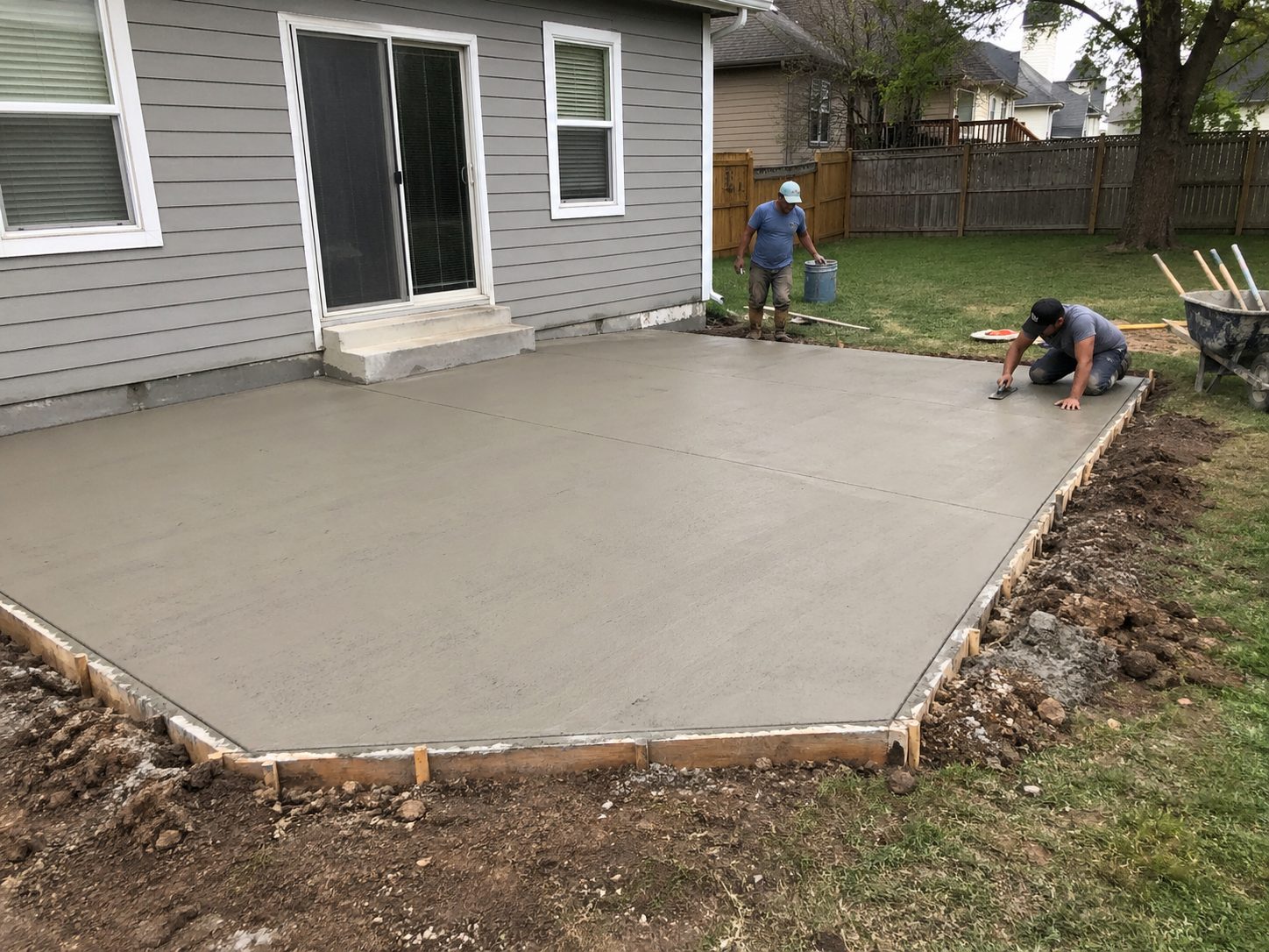 Concrete patio pour in progress at a Lee's Summit, MO residential property